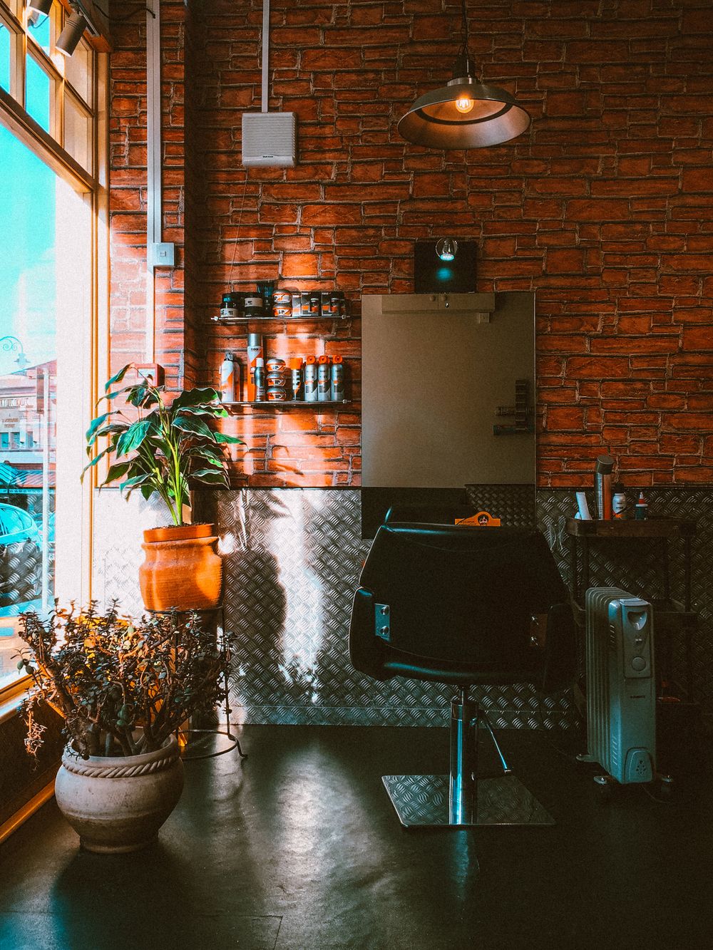 Bright salon interior with a brick wall and plants